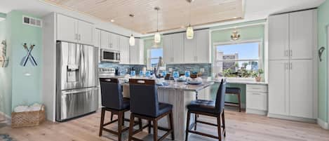 Updated Kitchen with Stainless Steel Appliances, Soft Close Cabinets, and a Built-in Workspace (with a partial view of the Gulf of Mexico!)