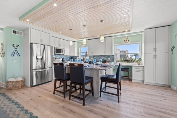 Updated Kitchen with Stainless Steel Appliances, Soft Close Cabinets, and a Built-in Workspace (with a partial view of the Gulf of Mexico!)