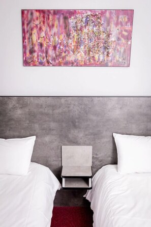 Unit with two single beds. The exact unit will be assigned upon arrival. Views, colors, and decorations may vary.