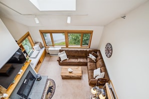 Bright and modest living space. Plenty of comfortable seating.