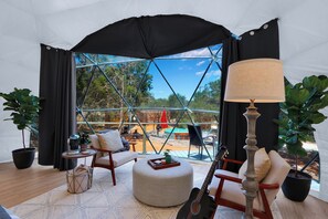 View of the living room and pool beyond.