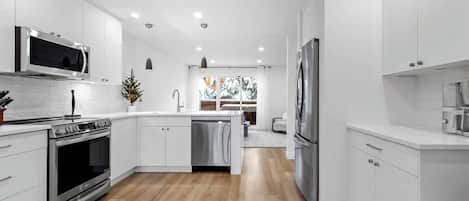 Main kitchen that has been fully remodeled with brand new appliances. The kitchen is fully stocked with everything needed to enjoy meals with family & friend's. 