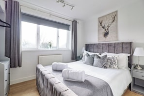 Rest peacefully in our cozy bedroom with plush bedding and natural light.