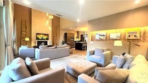 The living room is spacious and equipped with cable, a smart TV, and a fireplace, and boasts double height.