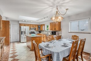 The kitchen and dining area are large, spacious and bright. Ready for a feast