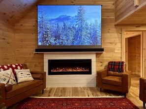 Living room with 100" projection screen above