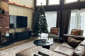 Celebrate the holidays or enjoy a cozy stay with a fireplace and a festive tree in the living area.