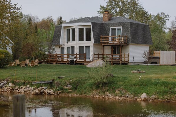 Channel front property with direct access to Thunder Bay, offering serene views and outdoor adventures.