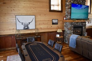 main floor living room one with pool table, game table and large TV
