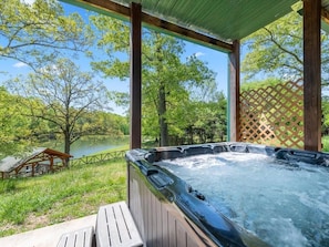Soak in the hot tub while enjoying a beautiful lake view.
