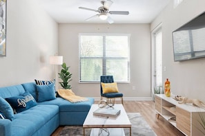 The well-designed living room overlooks a courtyard filled with tropical foliage and the sounds of doves cooing.