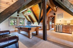 An upstairs loft space is the perfect entertaining spot with a pool table and a wet bar.