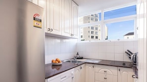 Kitchen with dishwasher and 2 burner electric stove
