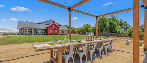 Large, open-air dining table overlooking the private soccer field.
