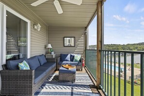 Screened in deck overlooking the pool and the lake