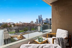 A balcony with city views. *(Chairs in the balcony are from the living area).