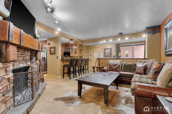 Cozy living room equipped with a TV and a warm indoor fireplace, creating the perfect space for relaxation and entertainment.