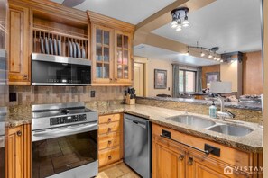 Fully equipped kitchen featuring modern appliances and a coffee maker, ready to meet all your cooking and beverage needs.