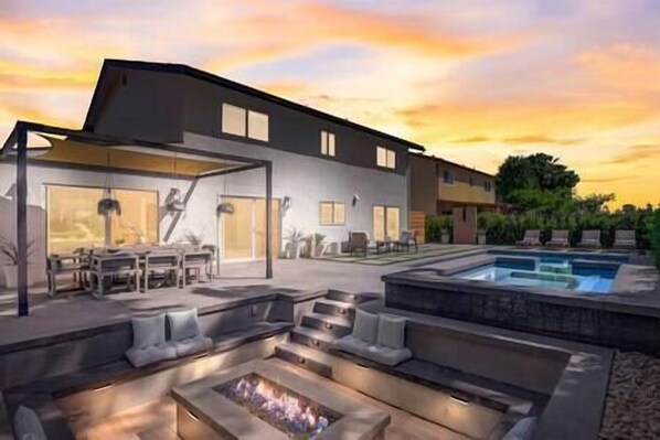 Gorgeous outdoor space, sunken firepit, spa, heated saltwater pool, outdoor shower.