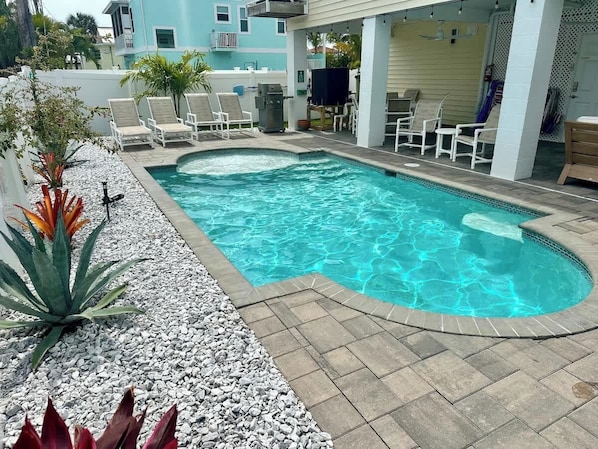 Heated Saltwater Pool with privacy fenced yard, new tropical landscaping, plenty of beach chairs, umbrellas, beach cart and cooler