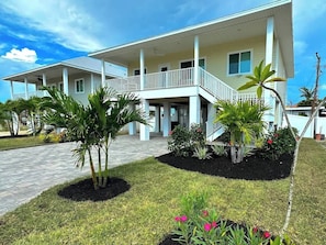 Elevated home all living space is upstairs on one floor~covered parking for 4 cars