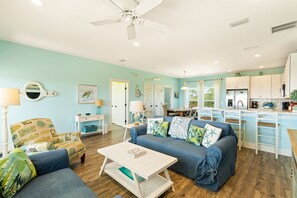 Living area open to kitchen and dining area.