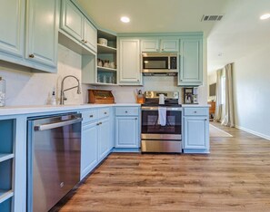 Simple, spacious kitchen layout with all new stainless steel appliances and faucet