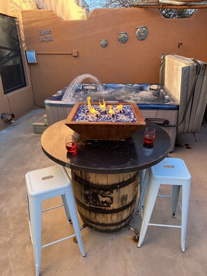 Have fun on the private patio with fire bowl, jacuzzi, tiki bar and table with seats!