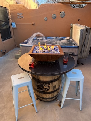 Have fun on the private patio with fire bowl, jacuzzi, tiki bar and table with seats!