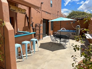 Have fun on the private patio with jacuzzi, tiki bar and table with seats!