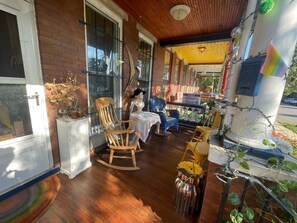 Porch space - twinkle lights, chess table, & rockers.