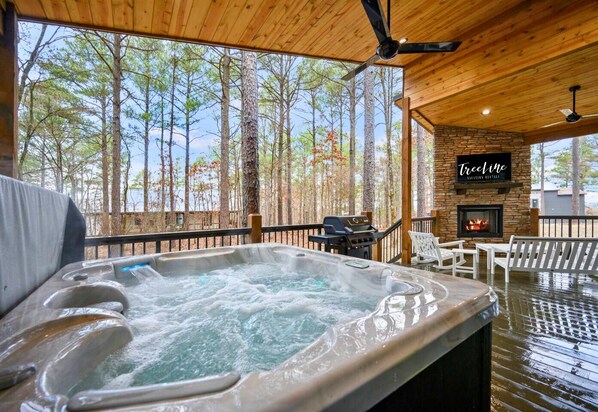 Soak in the hot tub with a beautiful forest view on the covered deck.
