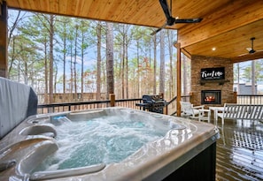 Soak in the hot tub with a beautiful forest view on the covered deck.