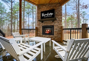 Gather around the outdoor fireplace for a cozy evening with friends.