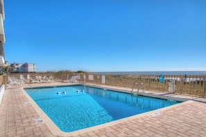 Take a cool dip in the sparkling pool after a fun day at the beach.