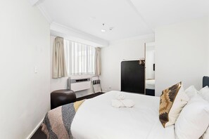 Retreat to this cozy queen bed, featuring a soft linens. It's the perfect place to rest and recharge.