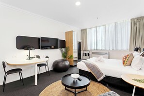 Relax and unwind in this stylish studio, featuring a comfortable living area and a sleeping zone.