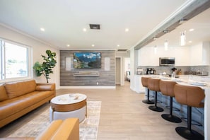 The luxe, open-design kitchen/living/dining space is an entertainer's dream!