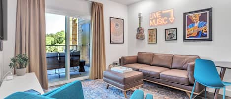 Spacious living with small desk or dining area, and tribute wall to Texas Music 