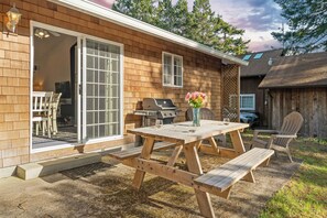 Quaint backyard with picnic table, chairs and BBQ