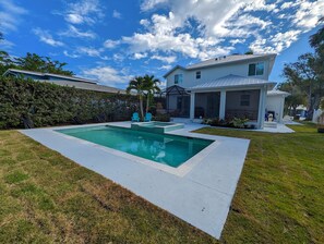 Back of the home with a BRAND NEW pool & spa!