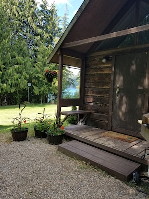 Small deck with propane BBQ and a water view.