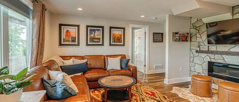 Gather around the fire in the cozy lower level family room! 