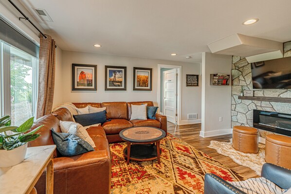 Gather around the fire in the cozy lower level family room! 