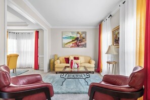 Primary living room with a ton of natural light and plush seating.