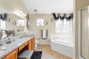 Full ensuite master bathroom: Indulge in a jacuzzi tub, a glass-enclosed standing shower, and a double vanity—your personal spa retreat!
