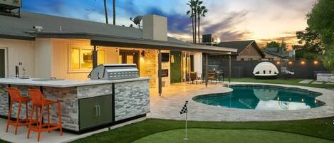 Your paradise backyard- putt putt, firepit, wet bar, BBQ Grill, cornhole, connect 4, and tons of outdoor seating