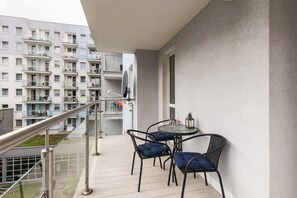 A spacious balcony with a seating area, perfect for enjoying your morning coffee or evening wine.
