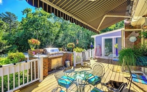 Huge deck and outdoor space- builtin grill with a two burner stove next to it.