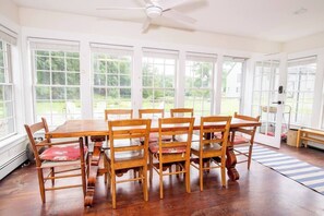 The huge family dining table is surrounded by windows for a panoramic view of the property